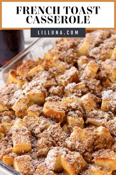 french toast casserole in a glass dish with powdered sugar on top and text overlay