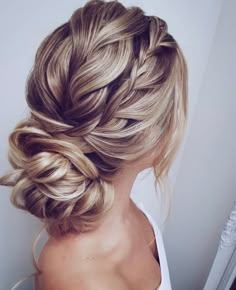 a woman with blonde hair in a braid updo