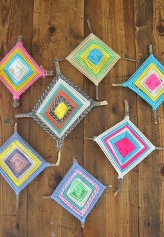 there are many square crocheted squares on the table together, all in different colors