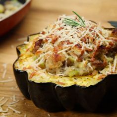 an eggplant stuffed with meat and cheese on a wooden table next to other dishes