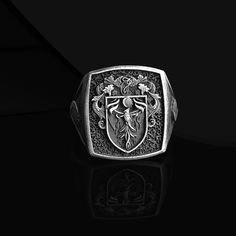 Silver Signet Custom Coat Of Arms Ring Introducing our magnificent Silver Signet Custom Coat Of Arms Ring, a true symbol of heritage and pride. This exquisitely crafted signet ring showcases your unique Family Crest with stunning detail and elegance. Meticulously designed, this heirloom-quality piece is perfect for men who appreciate personalized jewelry. Embrace your family legacy with this Men Unique Heraldic Family Crest Ring that will undoubtedly become a cherished keepsake for generations t Classic Silver Ceremonial Rings, Classic Silver Signet Ring For Ceremonial Occasions, Luxury Ceremonial Silver Engraved Ring, Ceremonial Heirloom Silver Signet Ring, Symbolic Silver Signet Ring For Wedding, Classic Sterling Silver Jewelry With Coat Of Arms, Silver Signet Ring With Coat Of Arms, Silver Engraved Ring With Coat Of Arms, Formal Silver Rings With Coat Of Arms