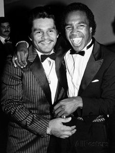 two men in tuxedos are posing for the camera