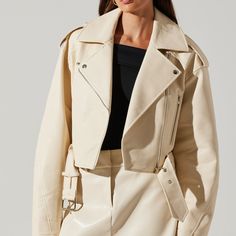 ASTR off white belted faux leather moto jacket Snap details at collar and shoulders Exposed front zipper Adjustable belt at waist, functional front pockets Faux leather, fully lined All White Leather Outfit, White Leather Jacket Outfit, Leather Jacket With Belt, Cream Leather Jacket, Off White Belt, Makeup Order, White Leather Jacket, Fall Break, Vegan Leather Jacket