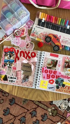 an assortment of crafting supplies are laid out on a table next to a pink bag