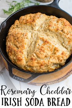 a homemade irish soda bread in a cast iron skillet with the words rosemary cheddar