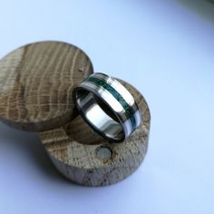 two rings are sitting on top of a piece of wood