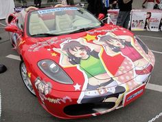 a red sports car with cartoon characters painted on it