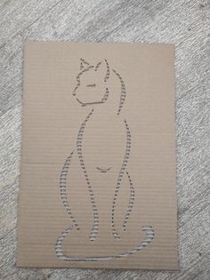 a drawing of a cat sitting on top of a piece of cardboard with lines drawn across it