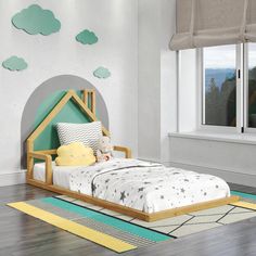 a child's room with a bed, rug and window