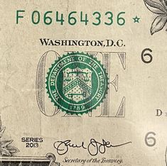 a green and white dollar bill with the words washington d c on it's side