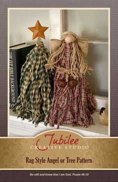 two cloth dolls sitting on top of a shelf