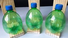 three green plastic bottles sitting next to each other