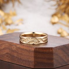 a gold ring sitting on top of a wooden box