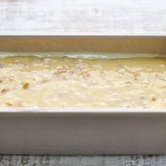 a metal pan filled with food on top of a wooden table