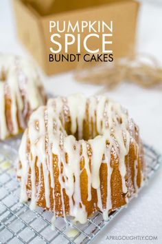 two donuts with icing sitting on a cooling rack