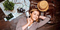 a woman laying on the floor next to her purse and cell phone with other items around her