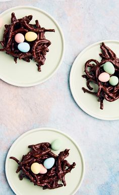 three plates with chocolate desserts on them and eggs in the middle one plate is filled with chocolate