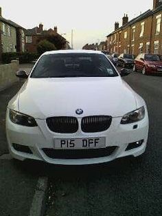 a white car parked on the side of a street