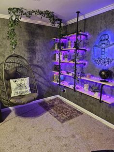 a living room filled with furniture and purple lighting on the walls, along with bookshelves