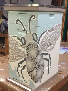 a bee painted on the side of a box