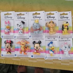 there are many disney figurines in the package