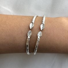 These stunning sterling silver West Indian bangles with intricate leaf ends are a must-have for anyone who loves Caribbean jewelry. Handcrafted from genuine silver, these bangles are a beautiful blend of tradition and modern elegance. Perfect for both men and women, they make the best gift idea for Mother's Day, Father's Day, birthdays, or Christmas. Caribbean bangles inspired by traditional craftsmanship. All of our silver bangles are made from solid 925 sterling silver and are stamped for authenticity. Each bangle is carefully handmade, making every piece unique. Traditionally, West Indian bangles are worn in pairs, but you have the option to choose a single piece or a pair, and they can be beautifully combined with other bangle bracelet styles. Material & Features: * Solid .925 Sterling Caribbean Jewelry, West Indian Bangles, Bracelet Styles, Idea For Mother's Day, Indian Bangles, Caribbean Style, Bangles Indian, Sterling Silver Bangle Bracelets, Sterling Silver Bangles