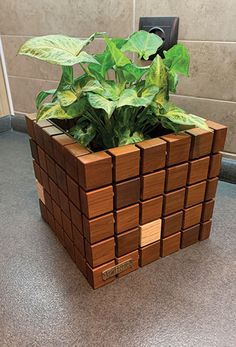 a planter made out of wooden blocks on the floor