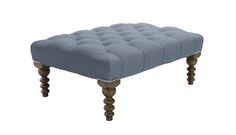 a gray ottoman with wooden legs and an upholstered foot rest in the middle