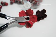 a pair of scissors with red flowers on them