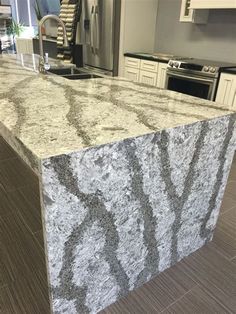 a kitchen counter top sitting inside of a kitchen next to an oven and refrigerator freezer