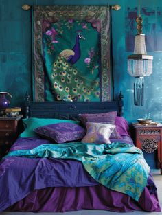 a peacock tapestry hanging over a bed in a room with blue walls and purple bedspreads