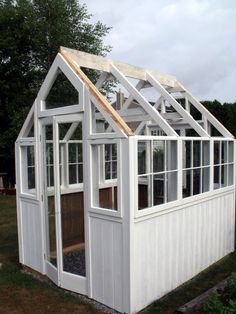 a small white building with windows and a roof