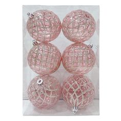 four pink glass ornaments in a clear box