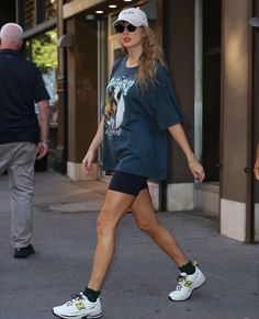 a woman walking down the street in shorts