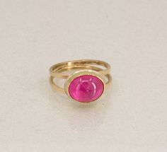 Beautiful bright pink tourmaline set in 18K Gold with handmade 14K Gold double band.  This pink tourmaline cabochon has a beautiful hot pink hue and is "eye clean".  The stone glows from within!  It reminds me of peonies blooming in my garden.  This is by far the prettiest Tourmalines I've ever seen!  I hand fabricated the elegant and sturdy double band in 14K Yellow Gold.  I really like the open space surrounding the Tourmaline setting which is set horizontal a.k.a east to west setting.  The se Peonies Blooming, Resize Ring, Rubellite Tourmaline, Pink Tourmaline Ring, Tourmaline Ring, October Birthstone, Jewelry Ring, October Birth Stone, Gold Set