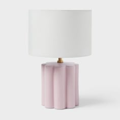 a pink table lamp with a white shade