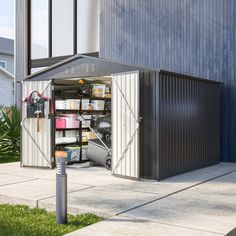 an open storage shed on the side of a building next to a sidewalk and grass