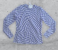 The Riley Checkered Mesh Top in Lavender is an ideal option for spring, featuring a fashionable checkered print and long sleeves. Long-Sleeve Mesh Top Checkered Print Color: Lavender Material: 92% Polyester, 8% Spandex Shown in Size Small Trendy Plaid Long Sleeve Tops, Trendy Long Sleeve Plaid Tops, Plaid Long Sleeve Top For Spring, Spring Long Sleeve Plaid Top, Fall Long Sleeve Tops With Grid Pattern, Chic Long Sleeve Gingham Blouse, Chic Gingham Long Sleeve Blouse, Fitted Plaid Long Sleeve Top, Fitted Long Sleeve Plaid Top