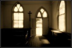 an empty church with sunlight coming through the windows