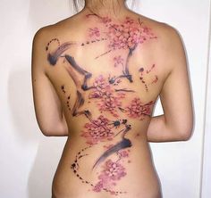 the back of a woman's body with flowers on it