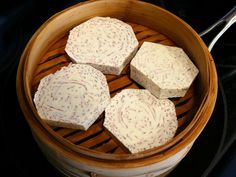 four pieces of cheese in a wooden bowl