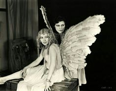 black and white photograph of two women with wings