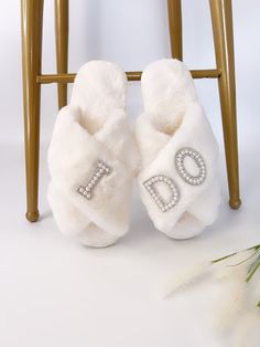 a pair of white slippers with the word do written on them sitting in front of a chair