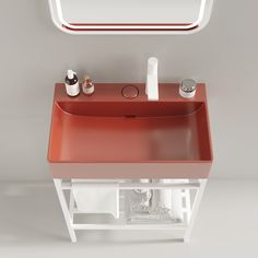 a bathroom sink with an orange counter top and mirror above it, in front of a white wall