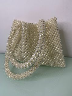 Knitkos ivory bag , beaded bag, Perl bag, milk bag, bead bag, bride bag, wedding bag, tote bag This model can FITS :  - Any IPhone/ tablet - car keys ID  - driver's license  - headphones / AirPods  - cardholder  - cash lipstick  - antiseptic Dimensions - Width:  (20 cm.) - Height:  (30 cm.) - length of handle (51cm) Bags are 100% handmade.This size making it perfect to hold your keys, cards, money and smartphones. I hope you collect great memories with this bag. SHIPPING  TIME (time 14-20 days) Cream Shoulder Bag With Pearl Handle For Shopping, Cream Rectangular Shoulder Bag With Pearl Handle, White Shopping Bag With Pearl Handle, White Bags With Pearl Handle For Shopping, White Beaded Bag For Everyday Use, White Tote Bag With Pearl Handle, Beige Pearl Bag For Everyday Use, Beige Pearl Bags For Everyday Use, White Tote Evening Bag For Shopping