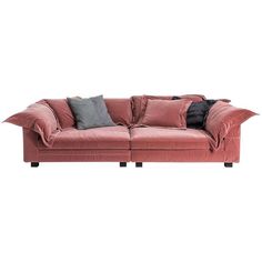 a red couch with two pillows on it