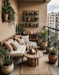 a balcony with potted plants and couches on the floor, along with a coffee table