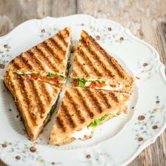 a grilled sandwich cut in half on a plate