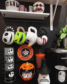 there are many halloween themed items on the shelves in this room, including cups and saucers