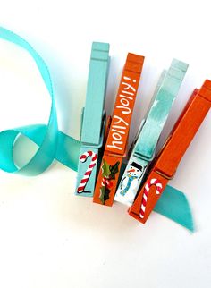 some candy sticks are wrapped in blue ribbon and tied to each other on a white surface